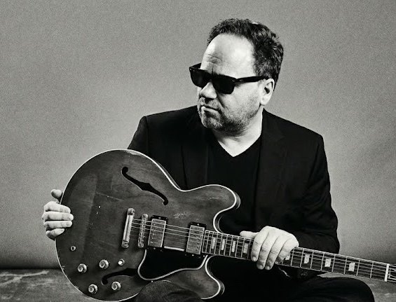 Chuck Credo IV with vintage hollow-body guitar