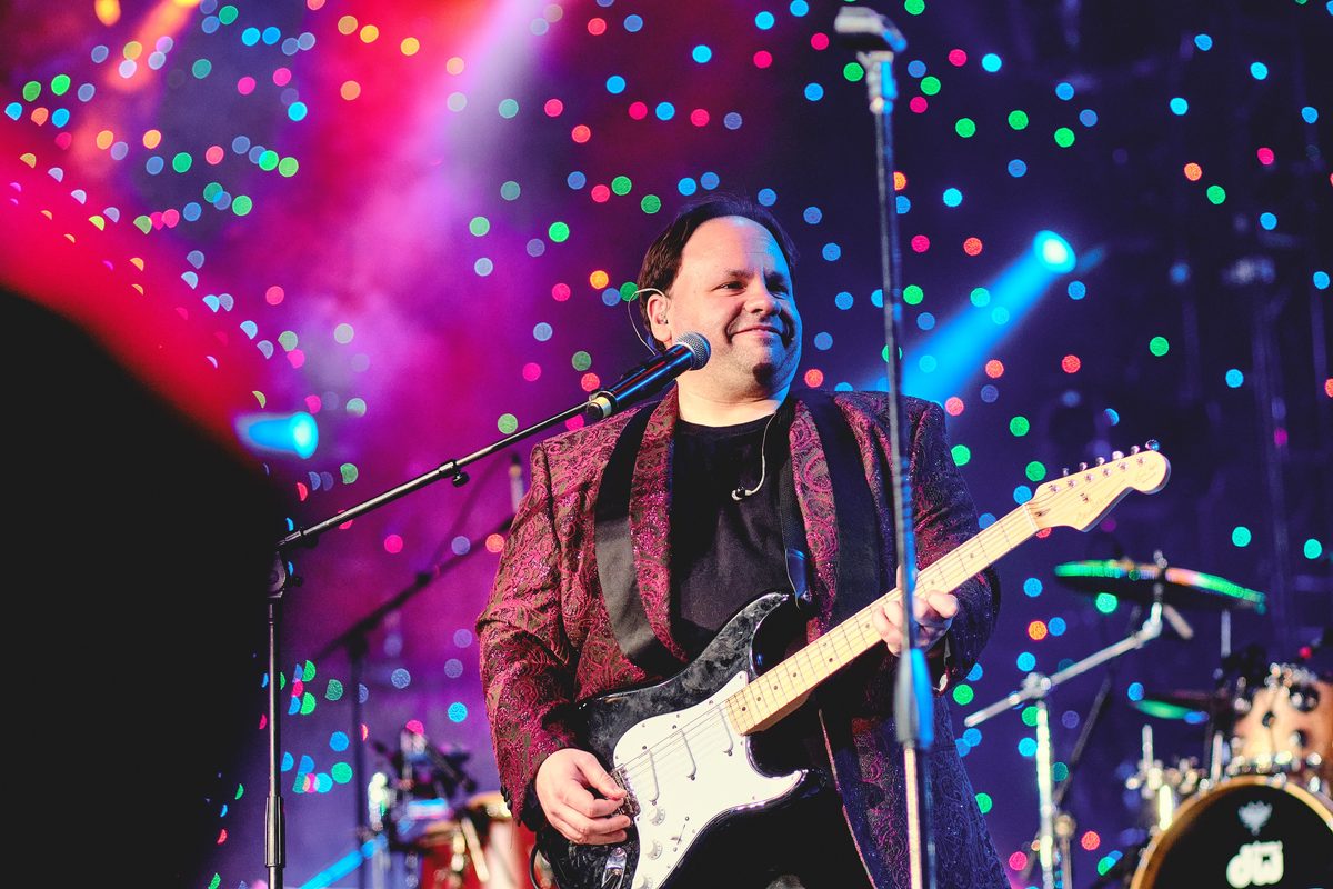 Chuck Credo IV performing under stage lights